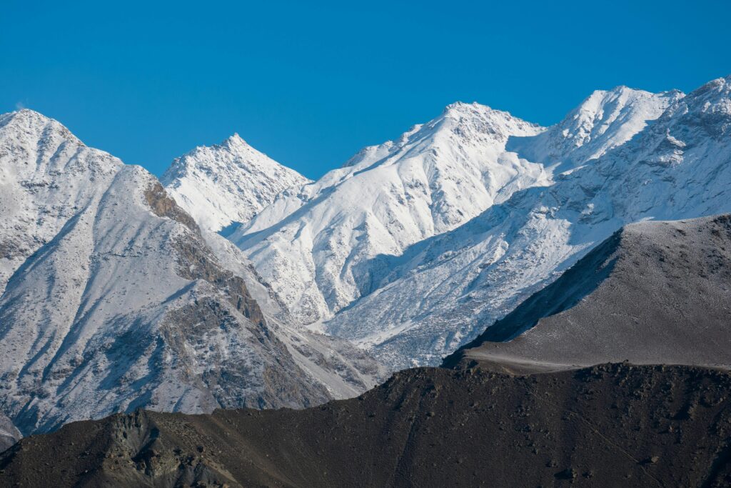Beautiful snowy peaks of Gilgit-Baltistan under a clear blue sky in winter.