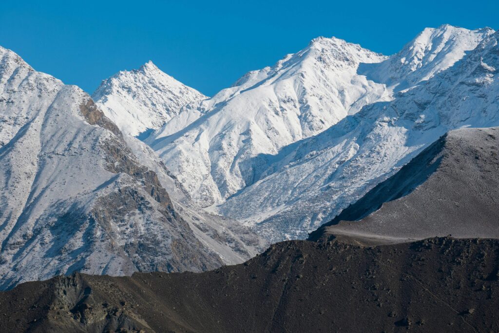 Beautiful snowy peaks of Gilgit-Baltistan under a clear blue sky in winter.