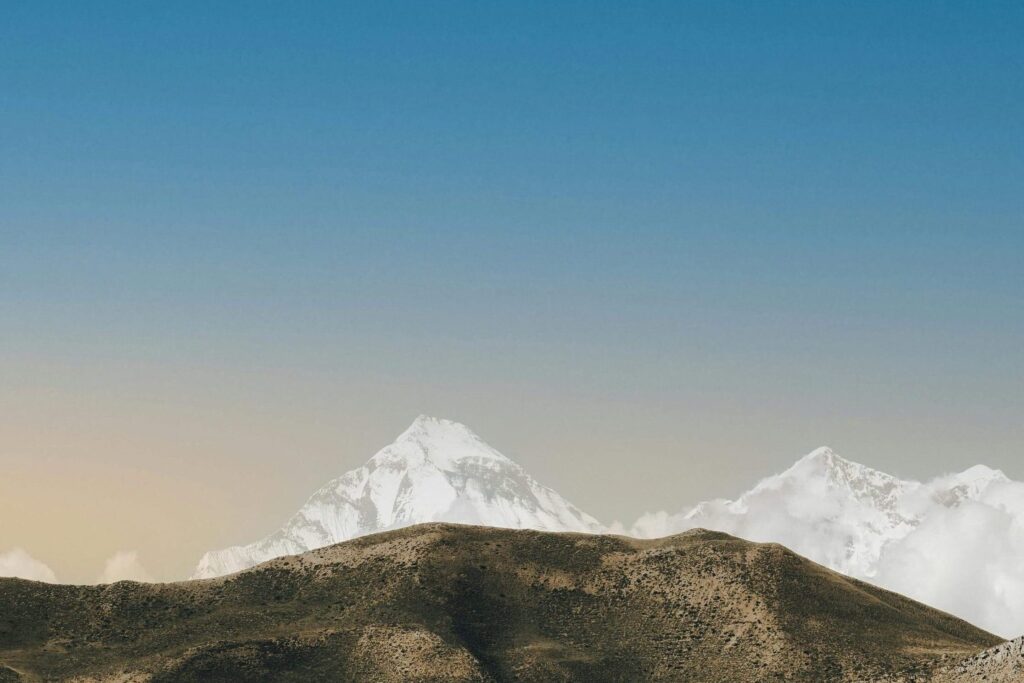 Stunning view of snow-capped peaks in Nepal with clear blue skies.